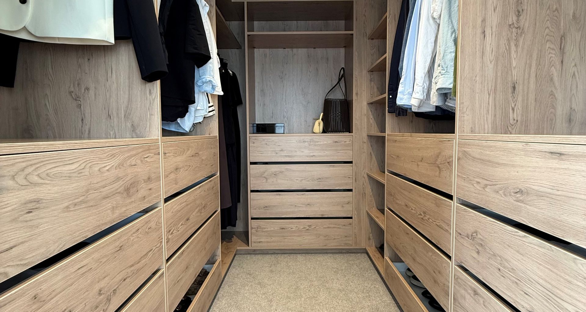 "We chose to upsize to 600mm-deep and 800mm-wide soft-close drawers, which increased the depth of the hanging space by 200mm. Because the width of hanging clothes is about 600mm, they fit perfectly. Even though the overall wardrobe depth extended by 200mm on both sides, there is still room for two people to be in there at the same time."