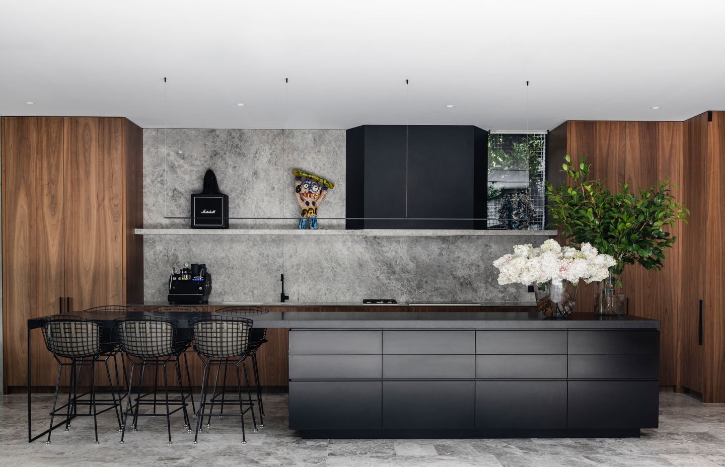 The kitchen island with its porcelain benchtop and open end provides an easy place to feed children.