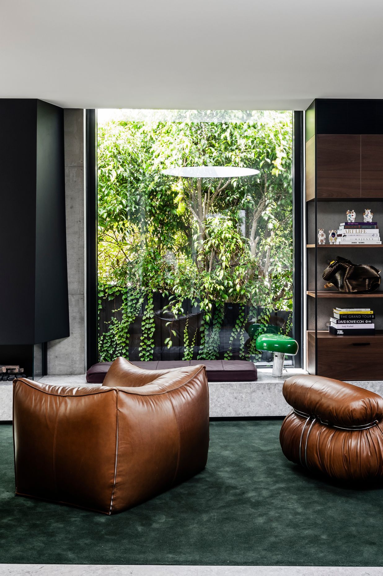 The dark green carpet and rich walnut veneer draws the outside into the lounge.