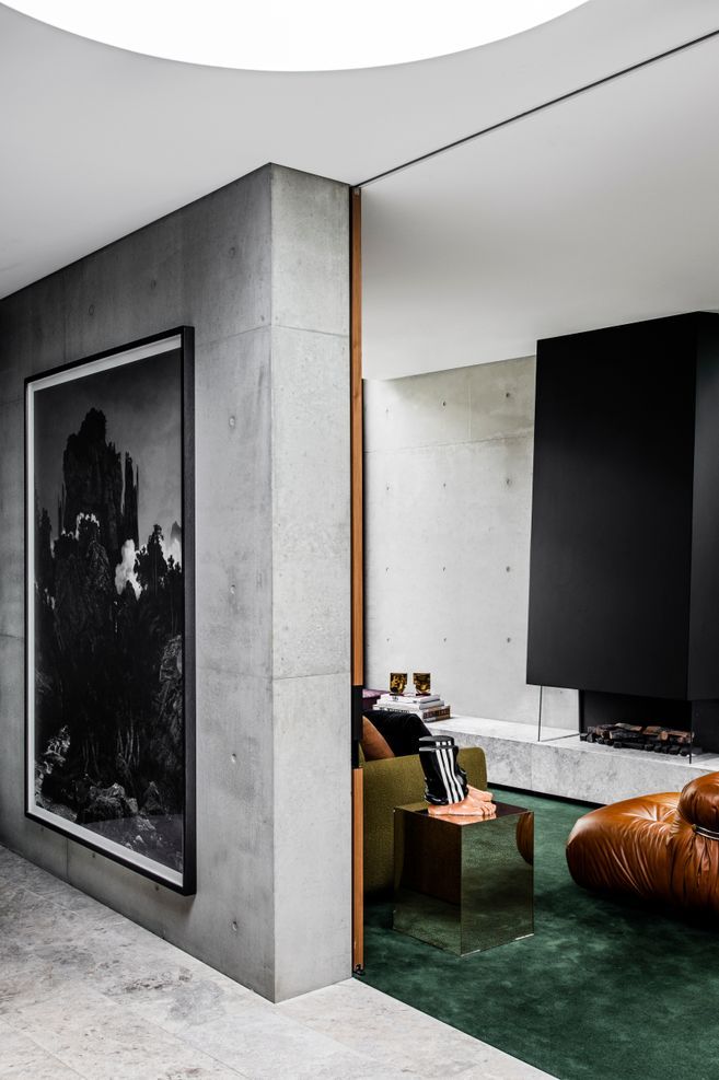 Pale concrete tones paired with biophilic greens ensure a serene palette throughout.