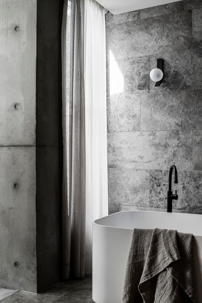 Linen drapes soften the light in a bathroom.
