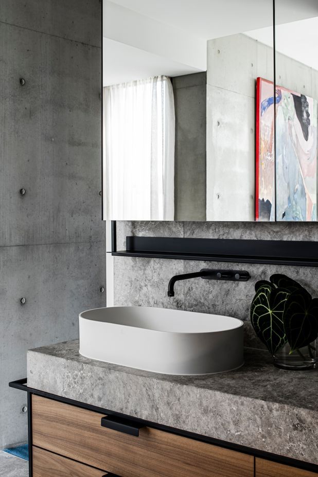 The detailing in the master ensuite integrates stone, steel and rich walnut timber veneer.