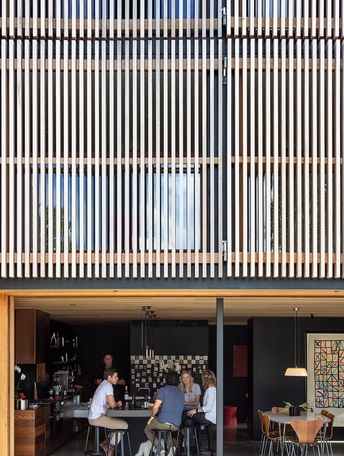 Seamless indoor-outdoor living above a dramatic facade.