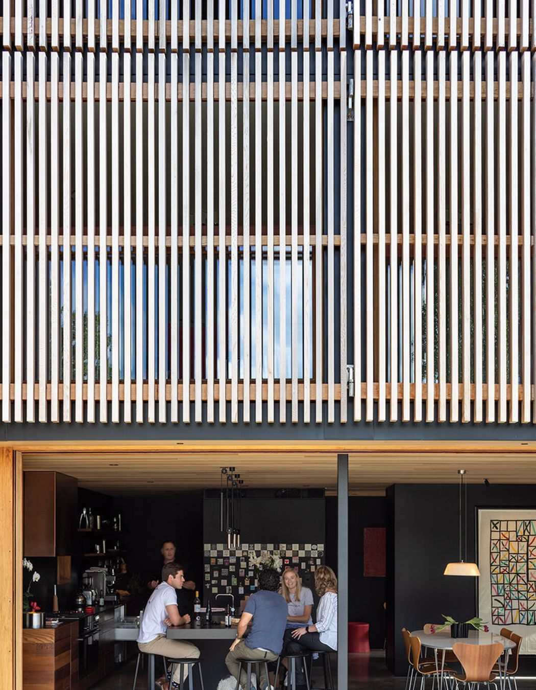 Seamless indoor-outdoor living above a dramatic facade.