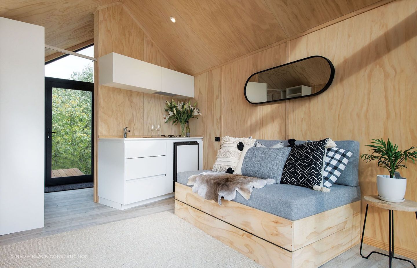 Custom in-built furniture is used to maximise space, complemented by textured furnishings