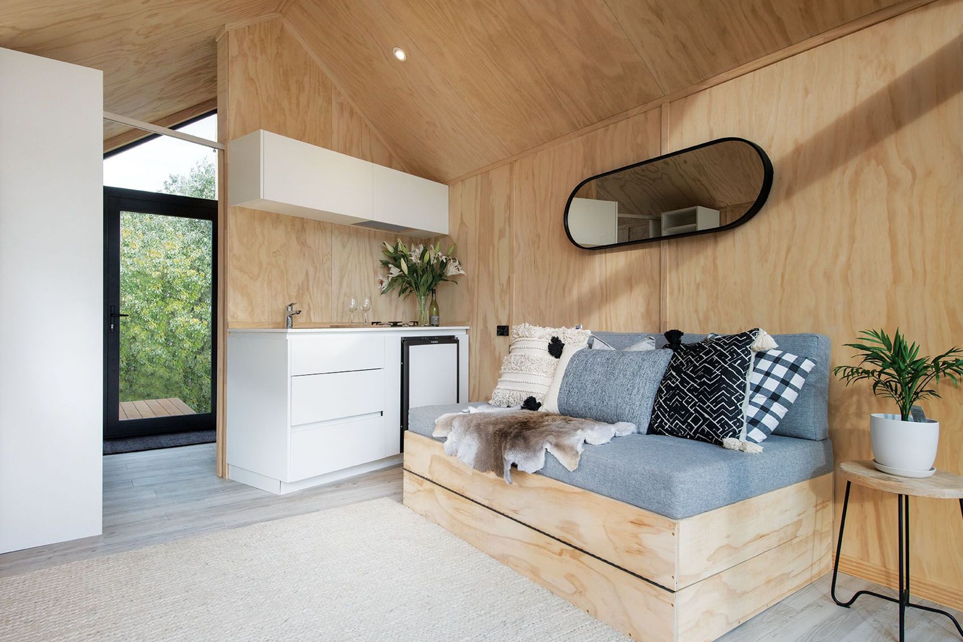 Custom in-built furniture is used to maximise space, complemented by textured furnishings