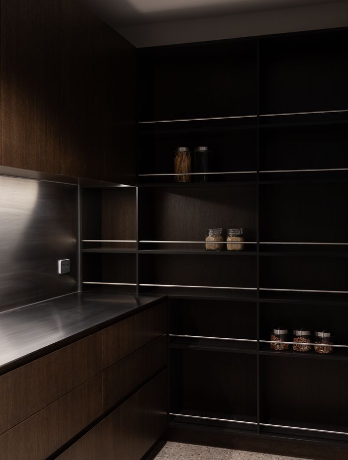 The butler’s pantry, a continuation of the chocolate brown cabinets and stainless steel benchtop | Photographer: Anna McLeod
