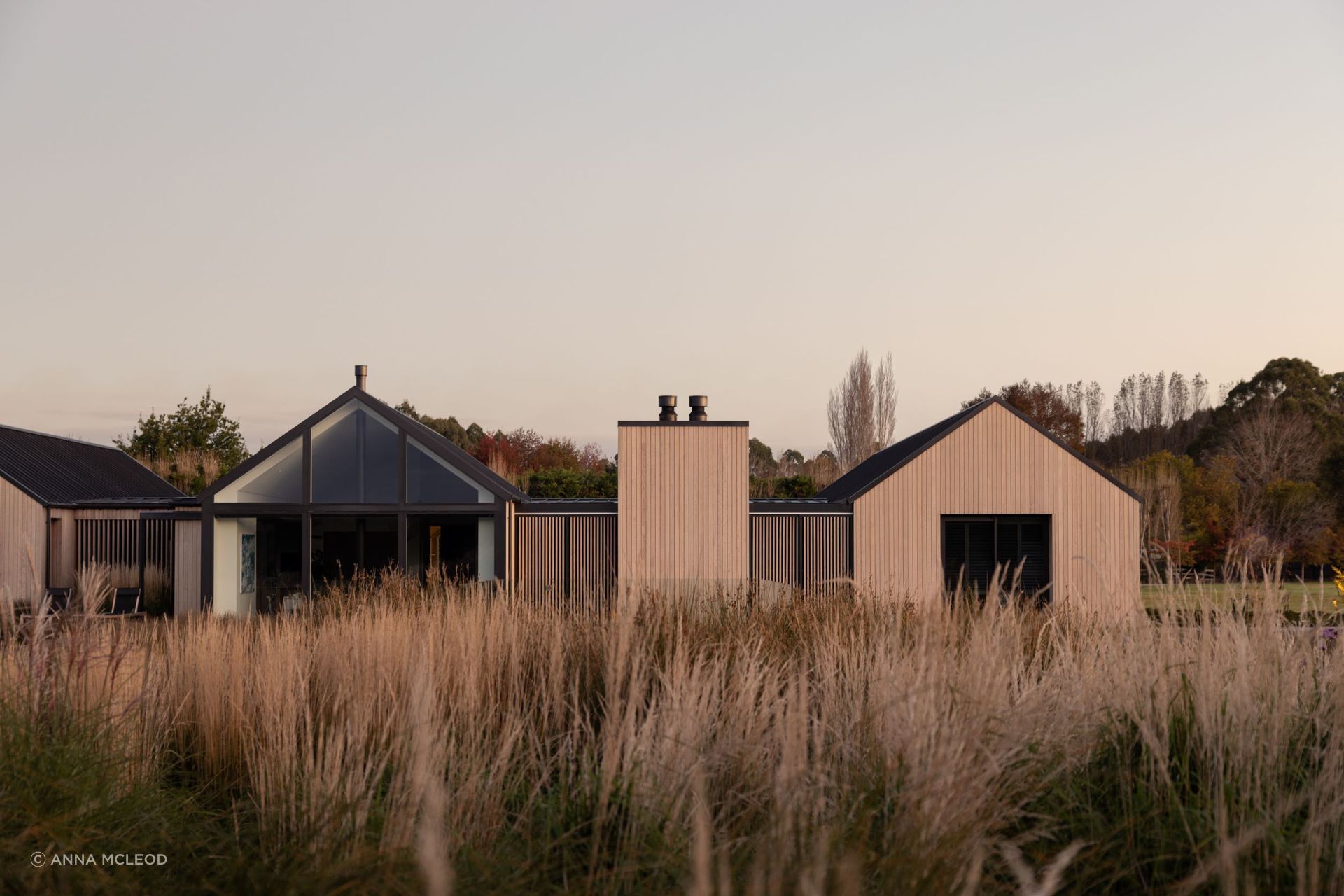 The northern elevation; heavily glazed yet still offering privacy with the option to pull across the sliding cedar screens | Photographer: Anna McLeod