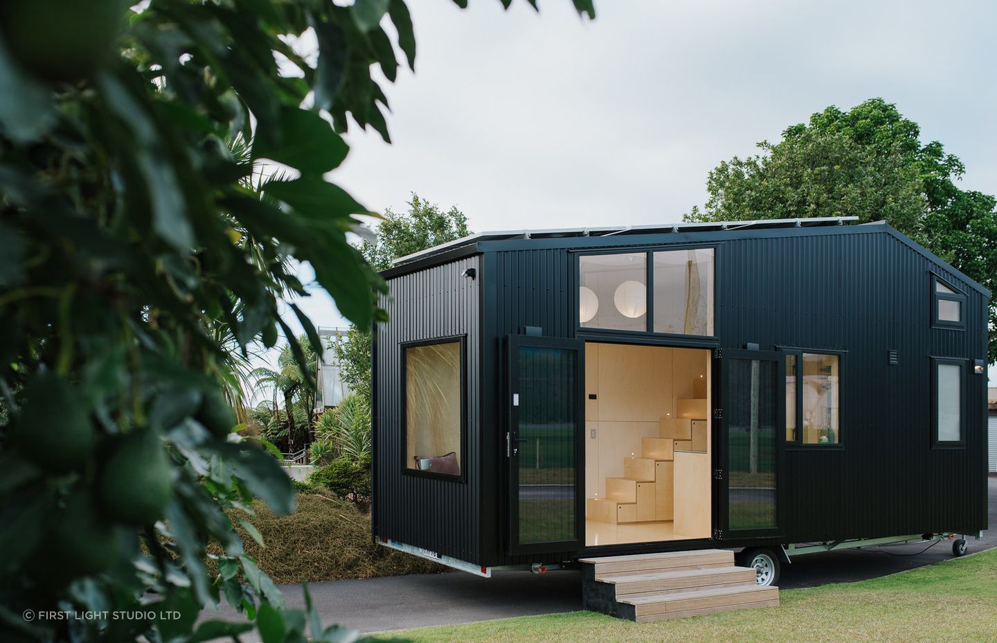 A tiny home with wheels presents both design challenges and opportunities, wonderfully demonstrated in this solar-powered tiny house in Ohariu by First Light Studio - Photography: Build Tiny