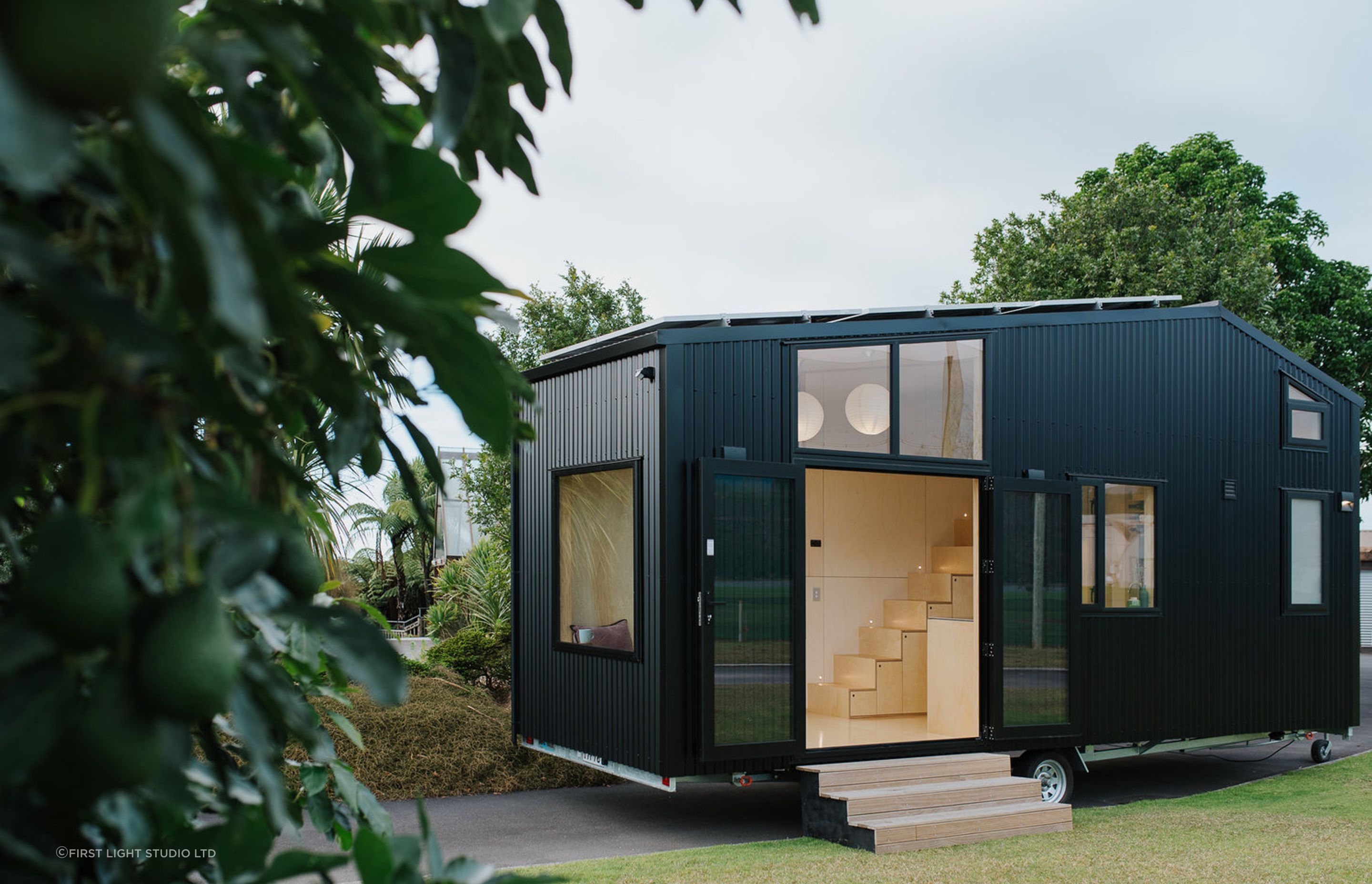 A tiny home with wheels presents both design challenges and opportunities, wonderfully demonstrated in this solar-powered tiny house in Ohariu by First Light Studio - Photography: Build Tiny