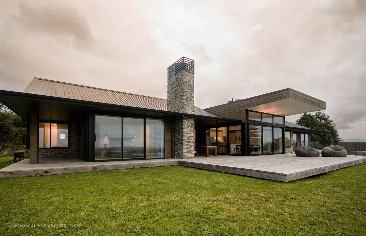 Natural materials like stone and cedar are elegantly used at Ohauiti House.