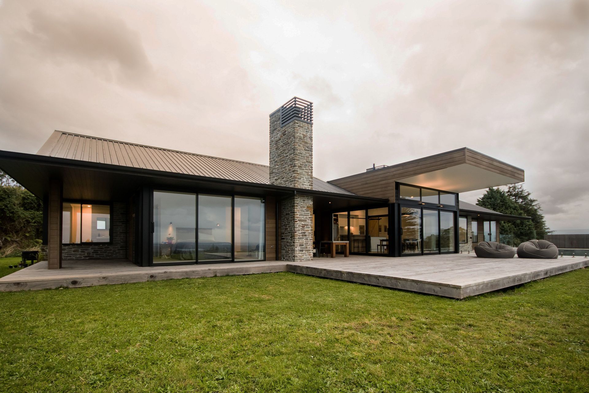Natural materials like stone and cedar are elegantly used at Ohauiti House.