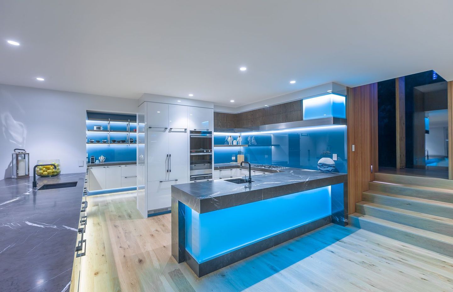 Glass used for maximum effect - splashback, island back, toekicks. Kitchen: Mal Corboy Design/Photography Kallan McLeod