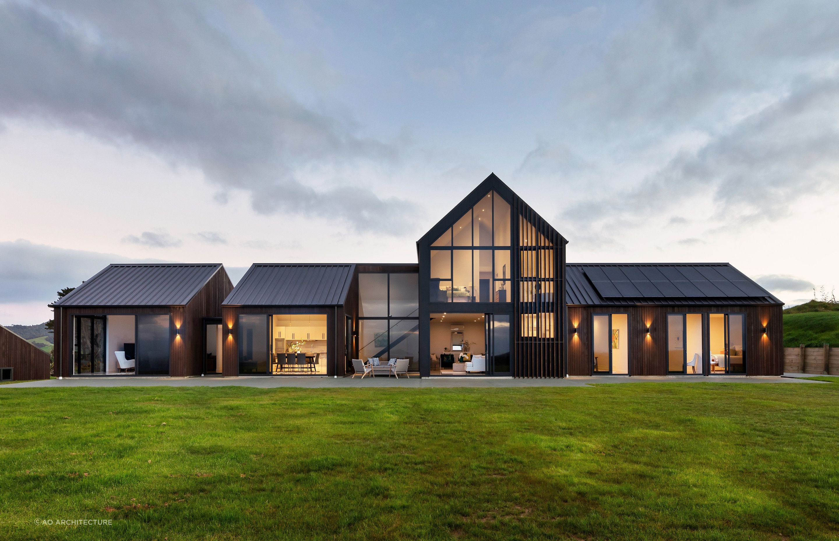 Dark stained timber, profiled metal and stunning design with this home in Pakiri — Photography: Stephen Entwisle