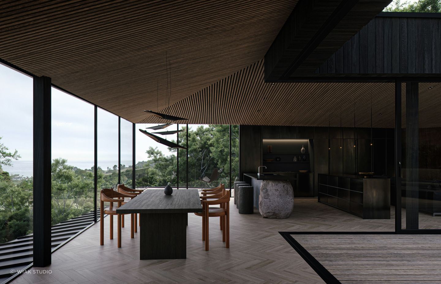 The floor-to-ceiling windows open the home up to the native bush surroundings and the Hauraki Gulf.