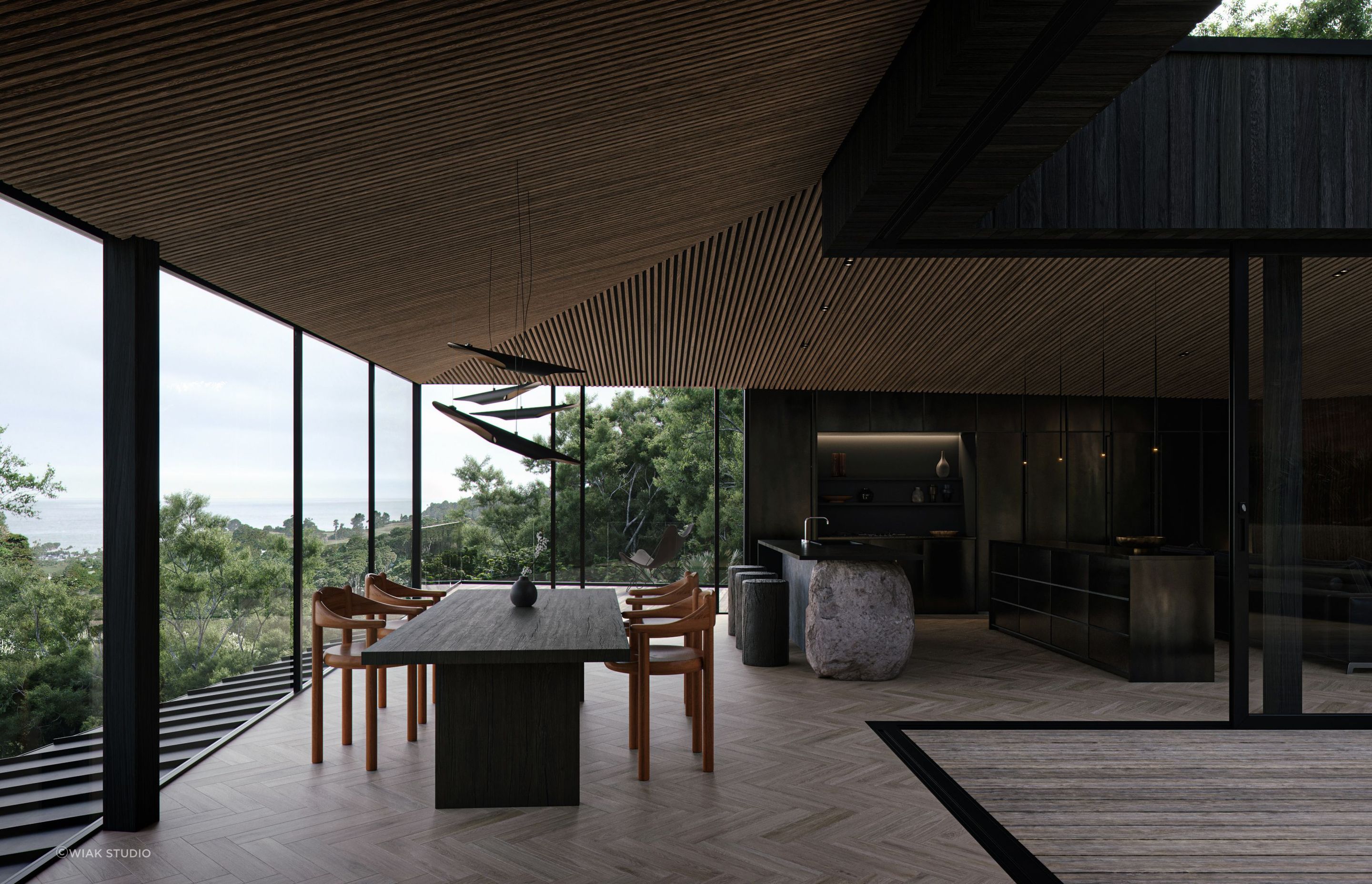 The floor-to-ceiling windows open the home up to the native bush surroundings and the Hauraki Gulf.