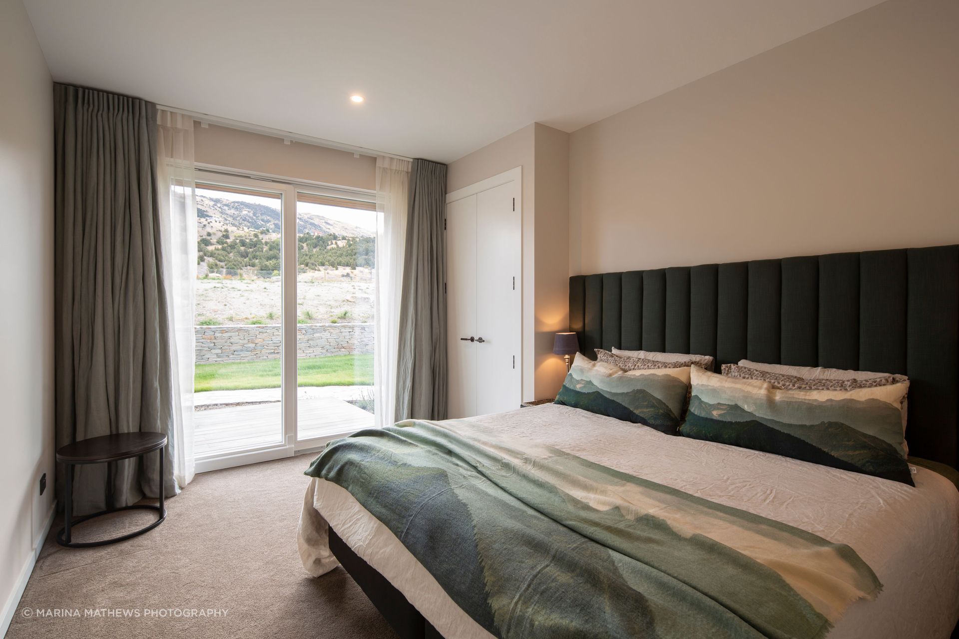 A comfortable guest bedroom takes in the colours of the environment.