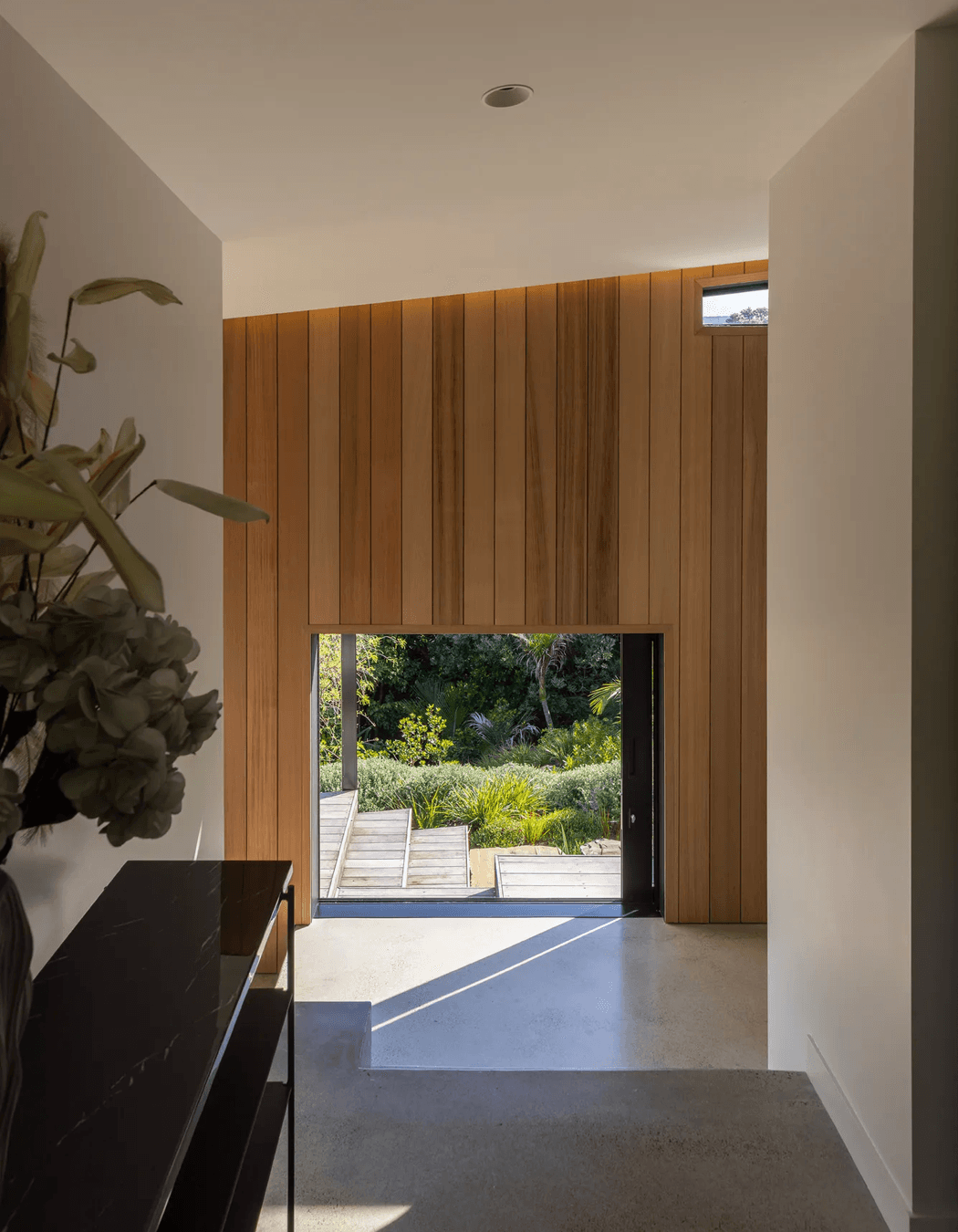 The home’s formal entry offers a direct sightline through to the south garden.