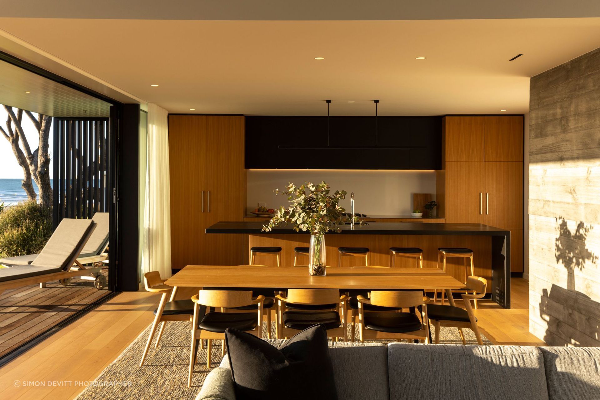 The morning light illuminates the kitchen, dining and living space.