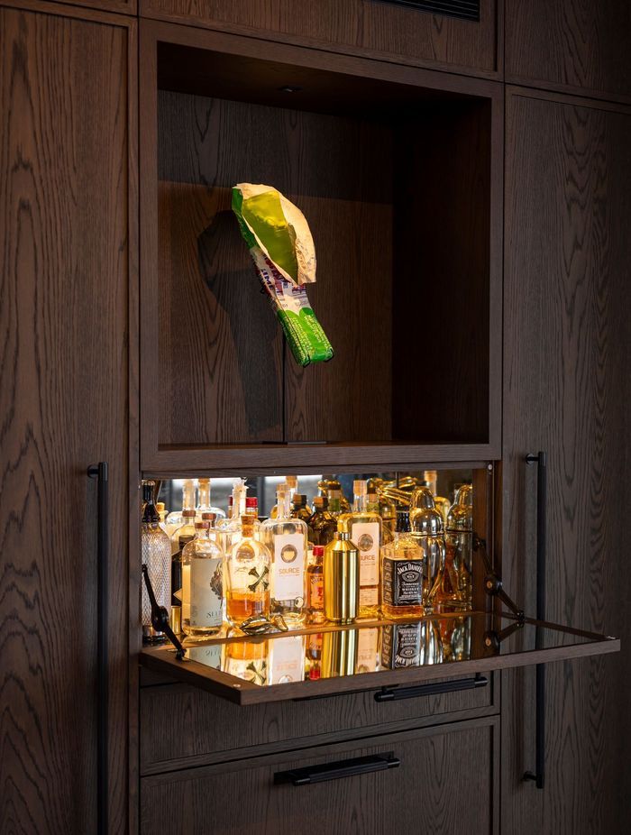 A mini-bar concealed in the kitchen cabinetry. The homeowners are art collectors - the K Bar sculpture is by Simon Lewis Wards.