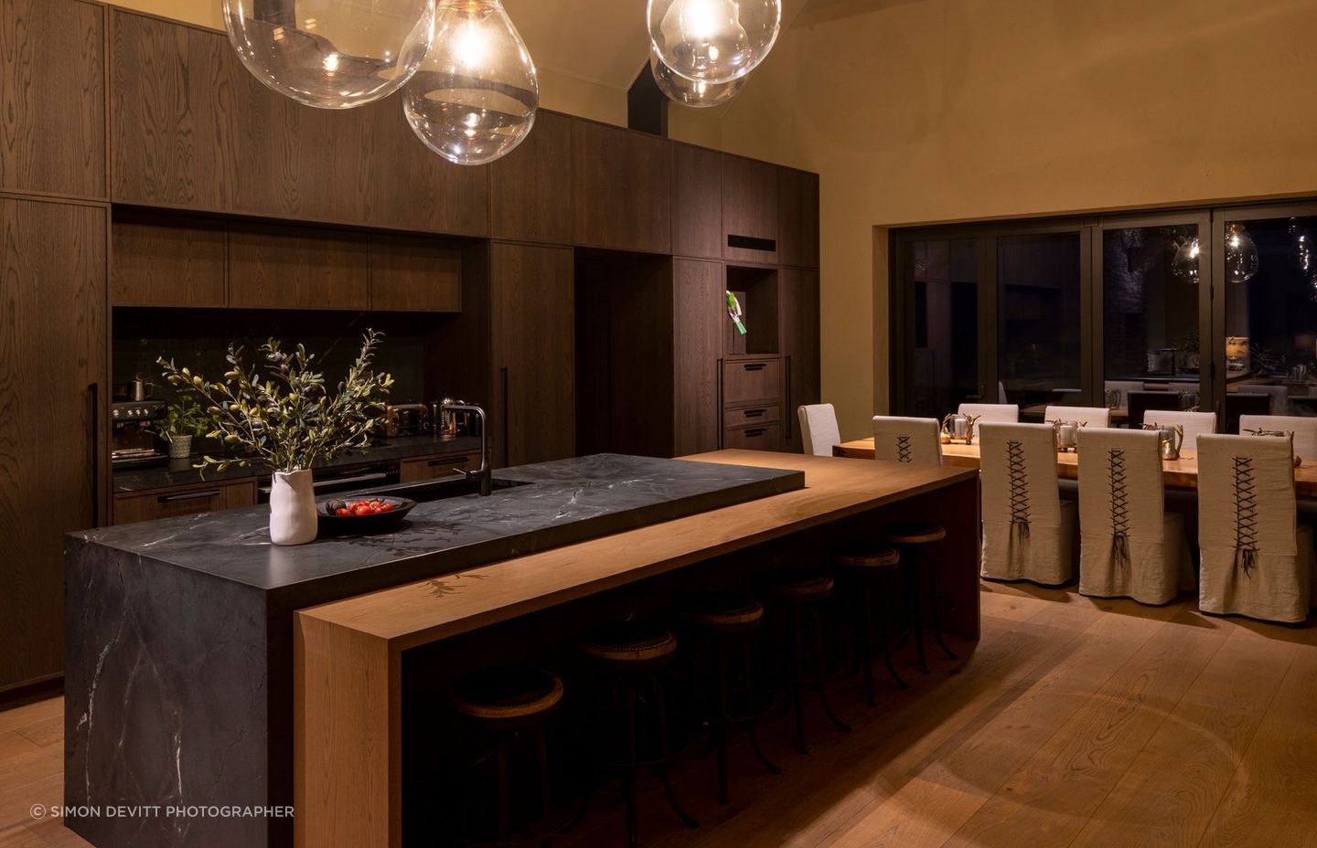 “The dining table is a swamp kauri slab from Dargaville, which was found early on and then a base was constructed for it. The dining chairs were custom made with leather detailing on the back,” says Vee.