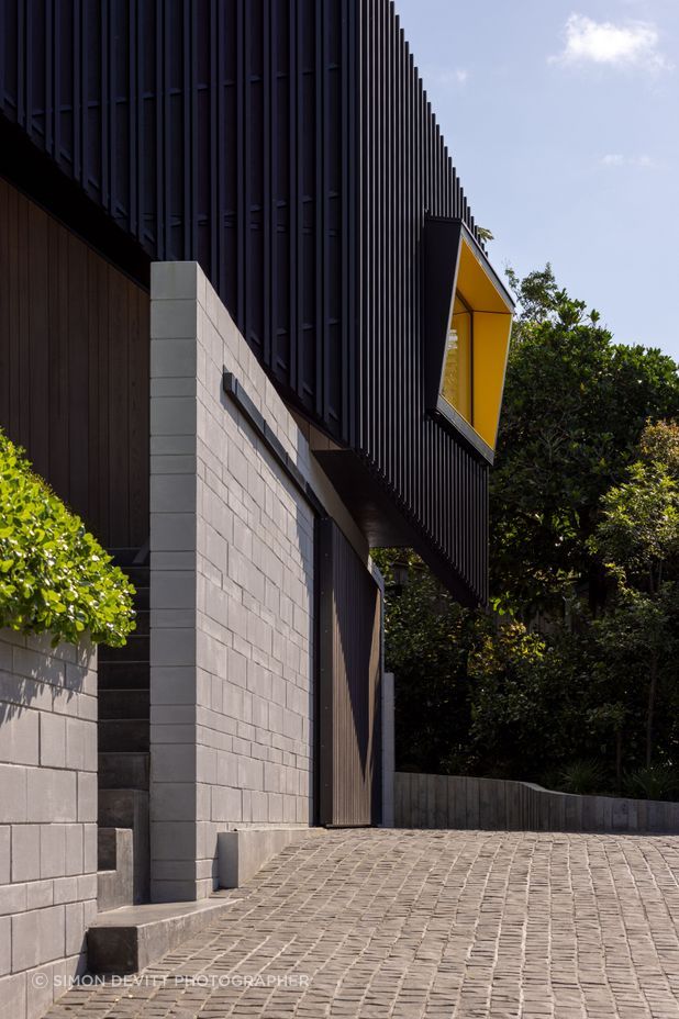 Angular windows with bright yellow soffits are orientated towards the views.