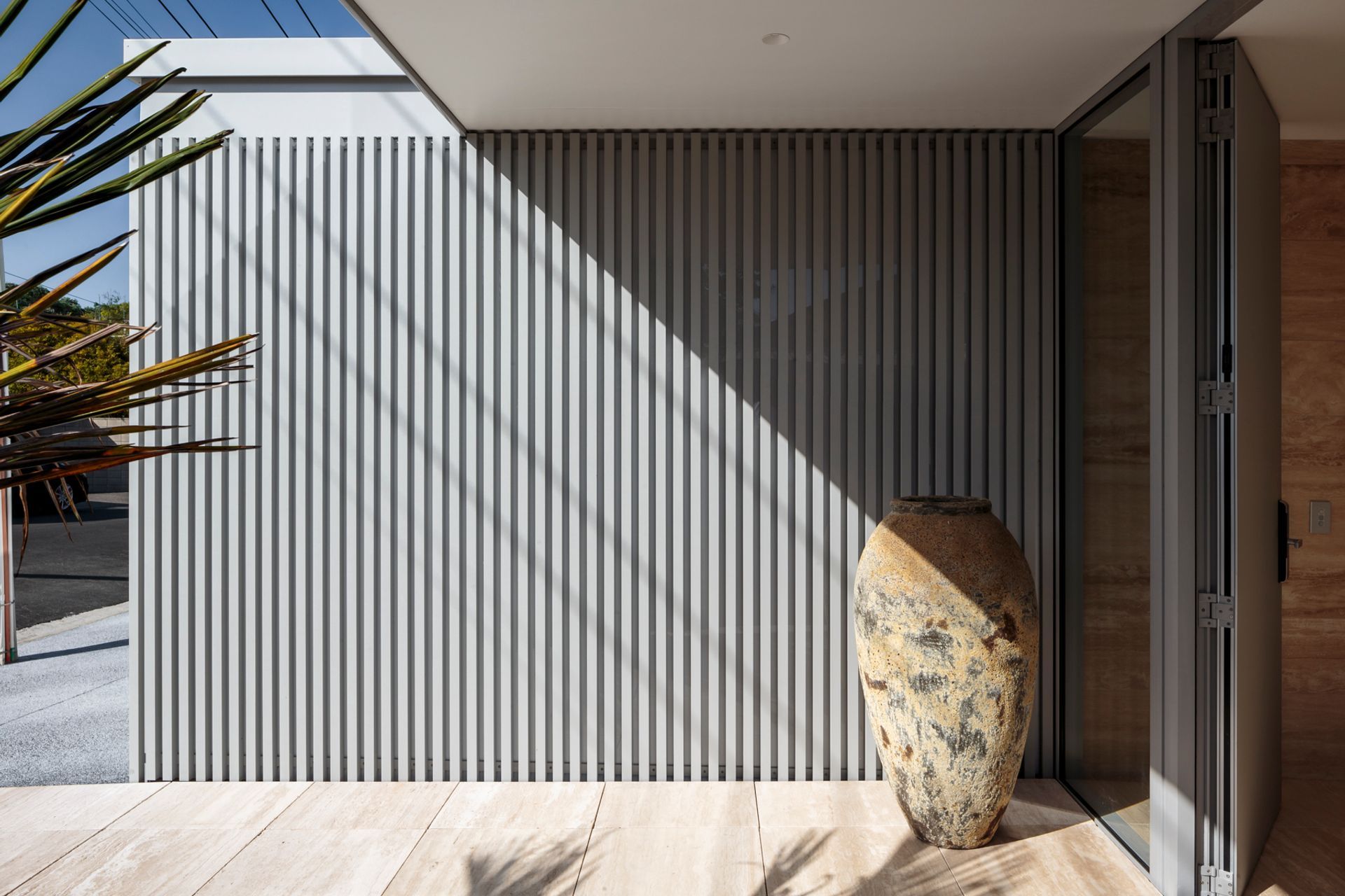 Its tiered, rectangular form is characterised by translucent cladding, aluminium battens, and just a few windows.