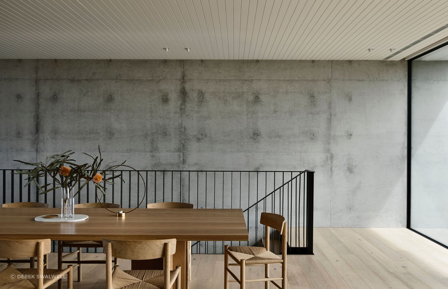 Pale timbers contrast against robust concrete structural elements.