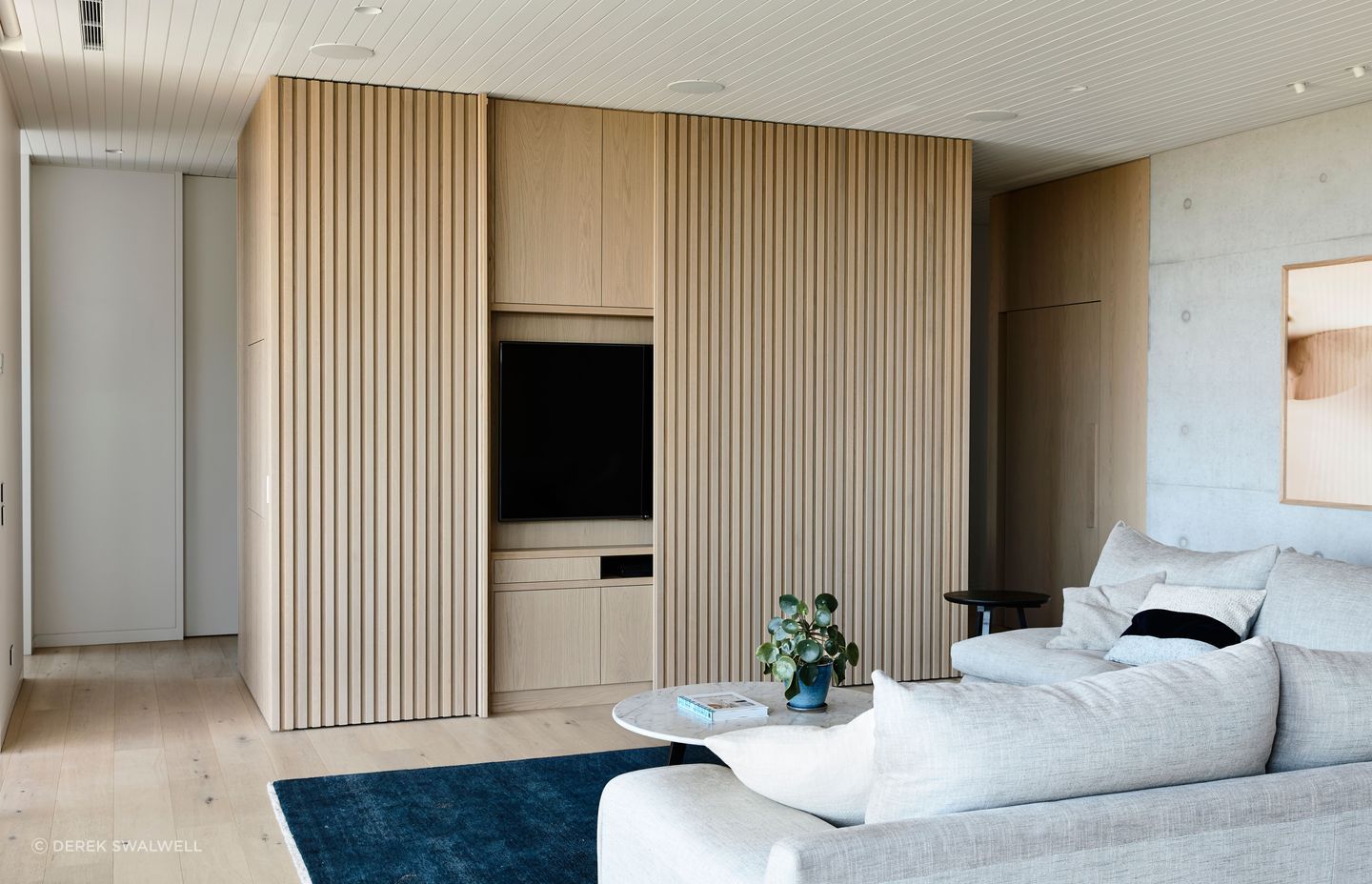 The entertainment zone is carefully concealed by panelled sliders when not in use.