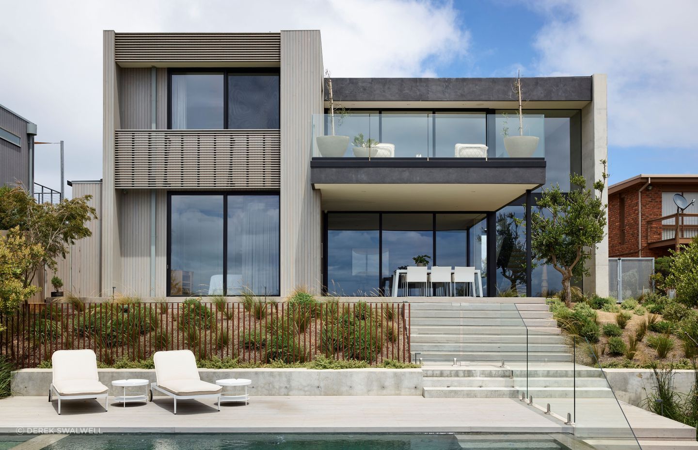 Elegant outdoor living and planters were selected to integrate with the interior palette. Planned Living Architects designed the architecture.