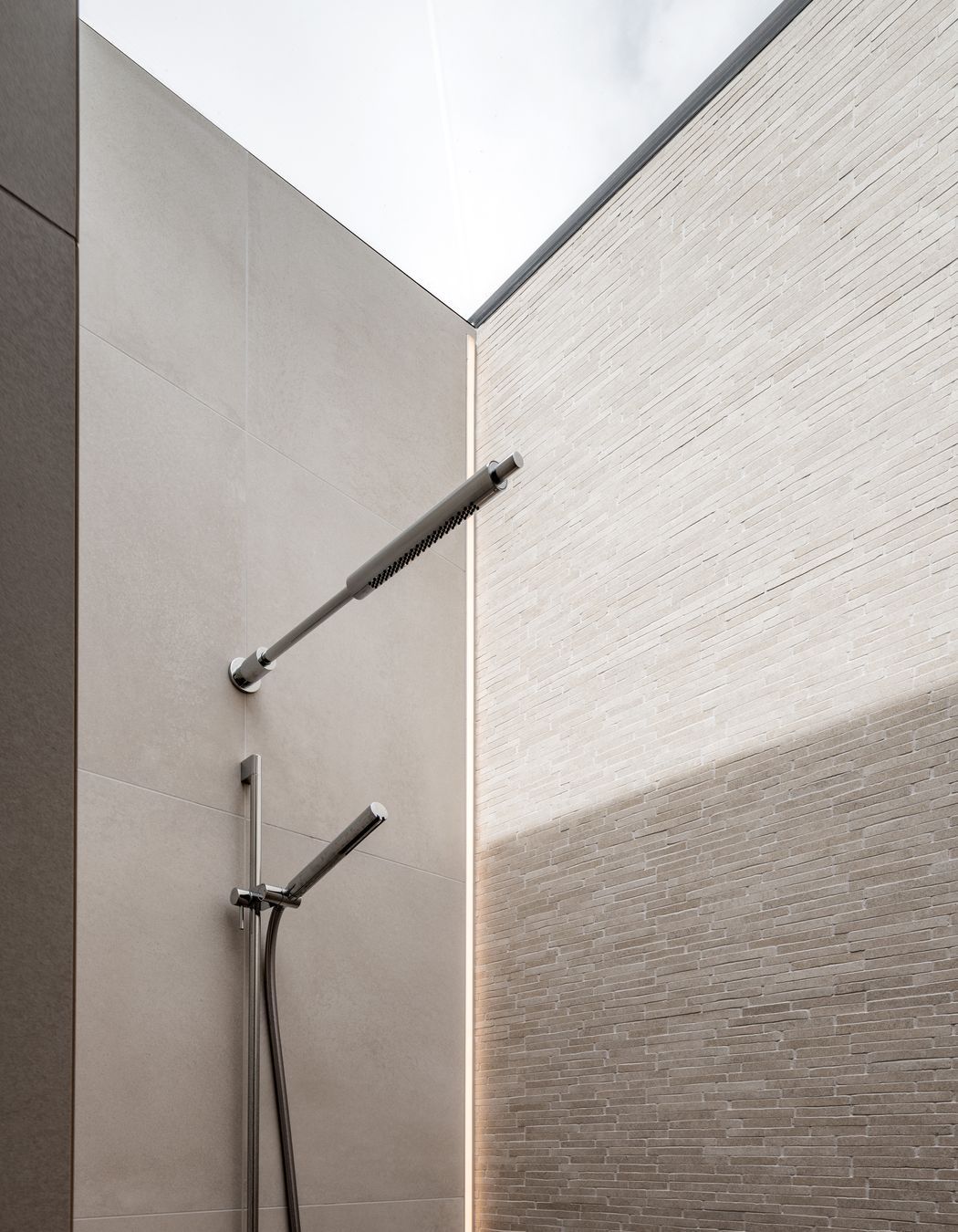 The shower had a skylight over the entire thing so there was nowhere to put a light. We actually recessed an LED strip vertically into the tile.”