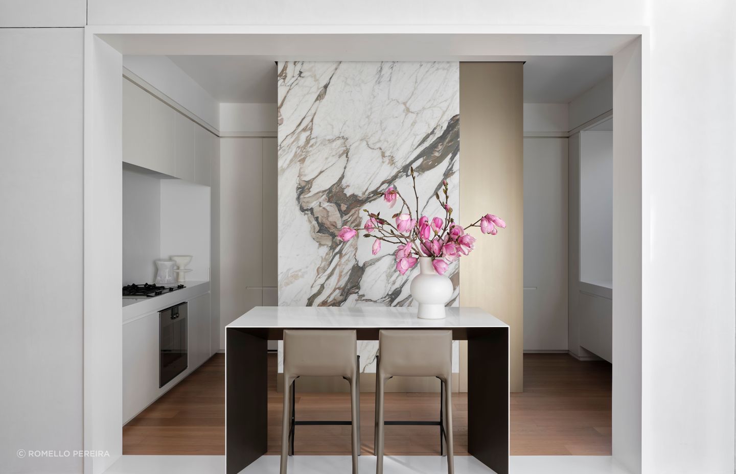 A jaw-dropping stone slab creates drama in the kitchen; the kitchen bar takes place of a traditional island.