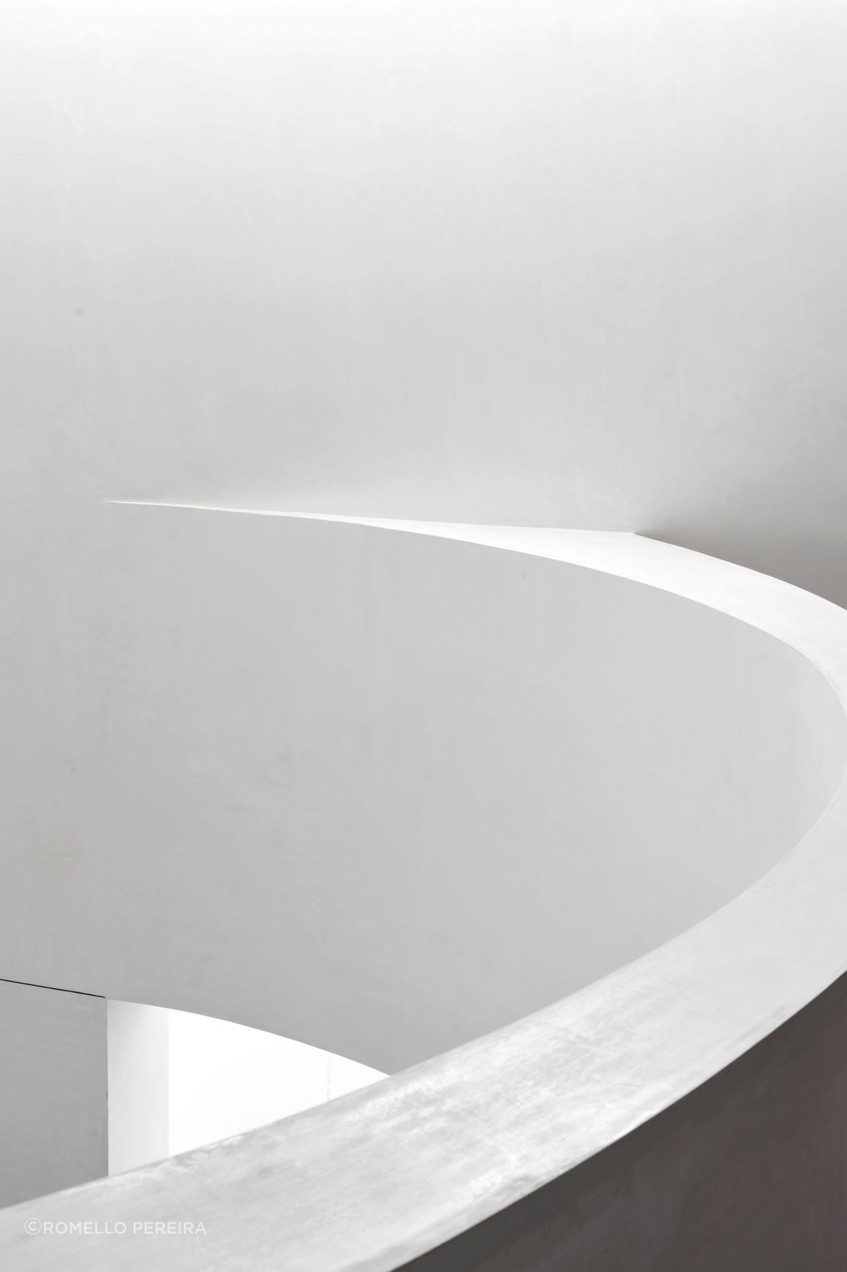 The curve of the mezzanine banister creates a strong gestural move in the new space.