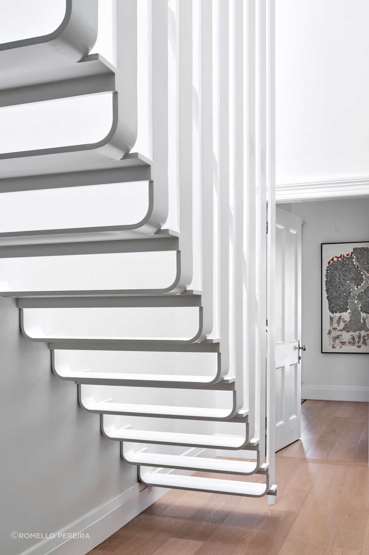 The upstairs mezzanine is accessed by sculptural stairs, celebrating the contrast of traditional and contemporary.
