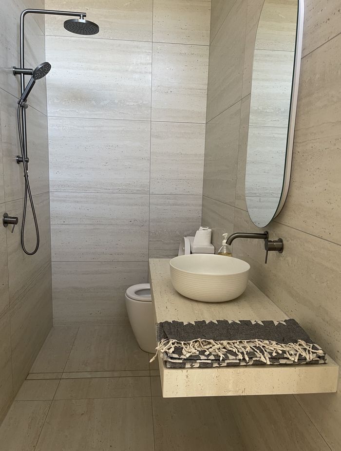 Sensi Roma Ivory Matt in a 596x1194mm profile has also been used for the bathroom vanity.