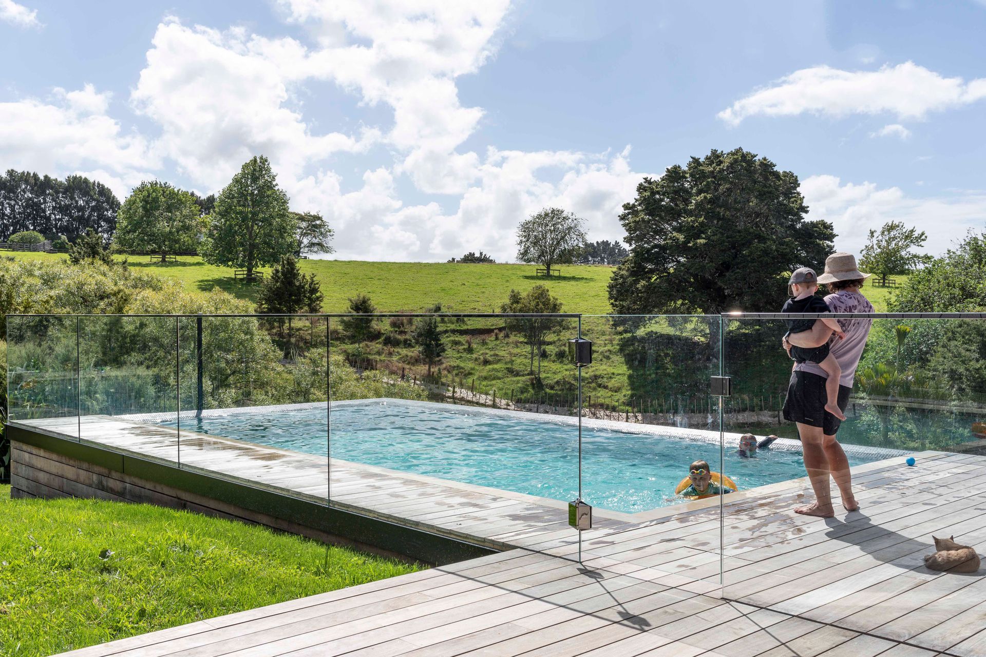 The family enjoys the stunning rural views across the land from the pool.