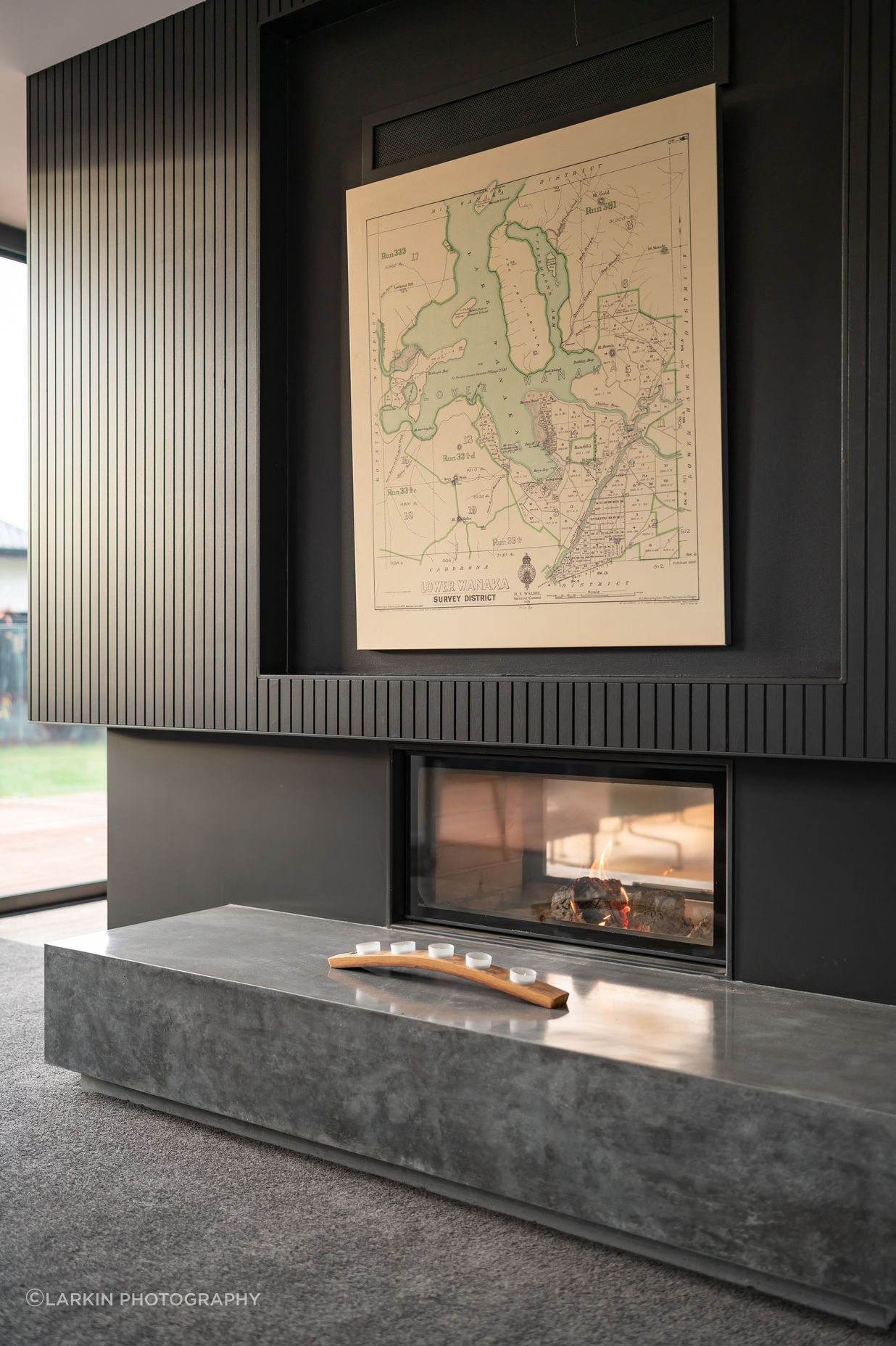 The Escea Spartherm double-sided fireplace divides two living areas without completely separating them.