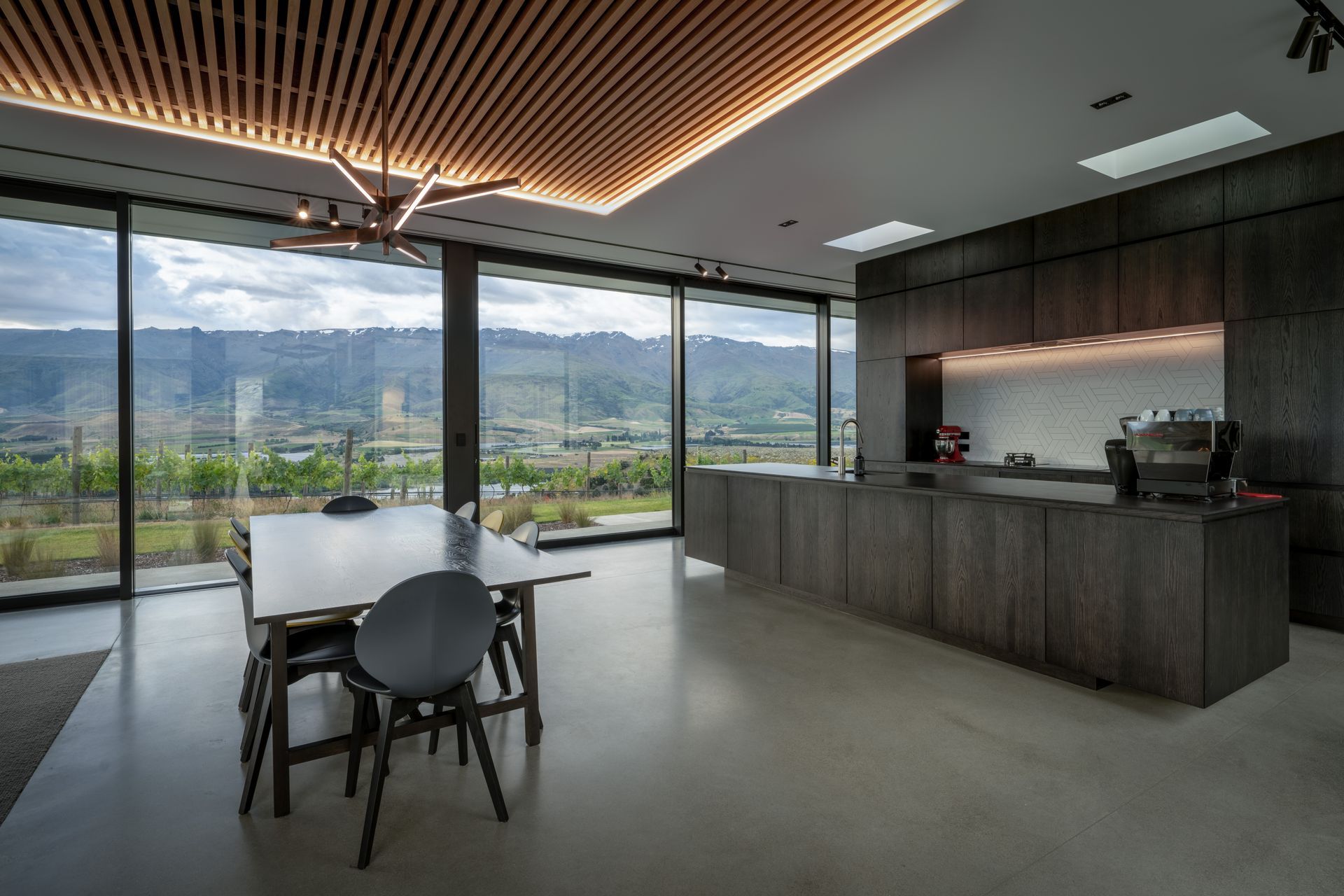 The kitchen and dining area, positioned to capture the outlook of the vineyard and Pisa mountain range. | Photographer: Simon Larkin