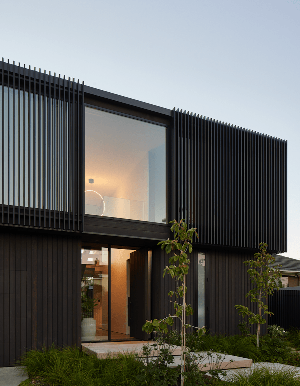 Beautiful landscaping leads to the front entrance.