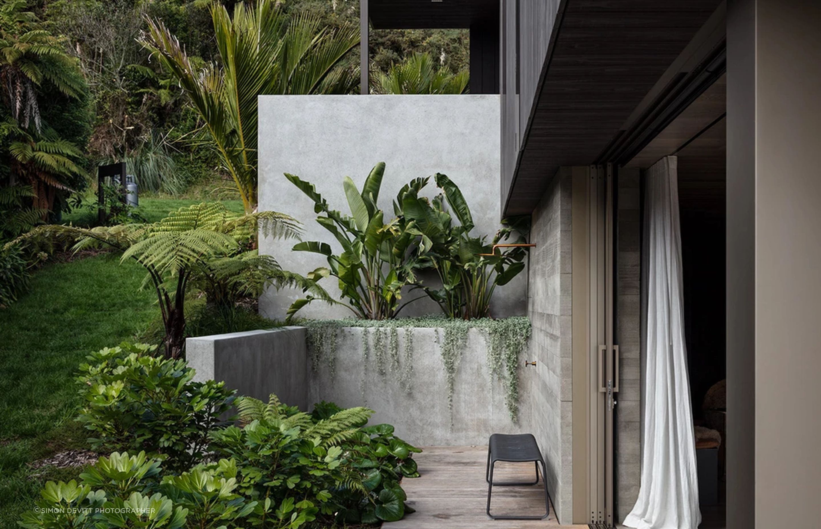 The outdoor shower. “There’s a double wall of concrete and the doors slide into a pocket between them. It looks easy, but actually building it is a real challenge,” says Evelyn. She mapped out the gardens, and Flora and Form designed and planted them.
