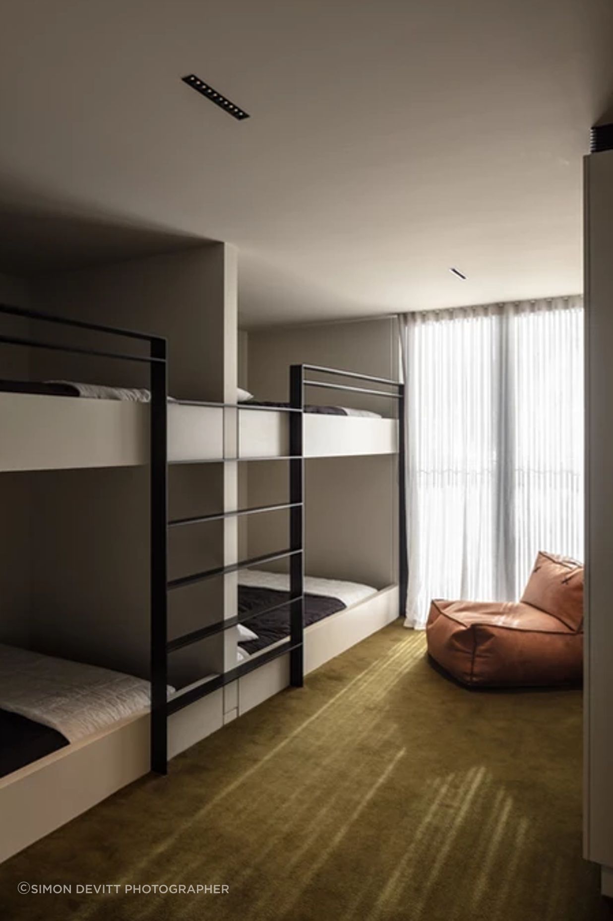 The spacious bunk rooms are upstairs. Fiona chose the Sallée carpet to fit the surroundings.  “We've got the green bush all around us. And then across the lake the hills are a really lush, khaki green.”