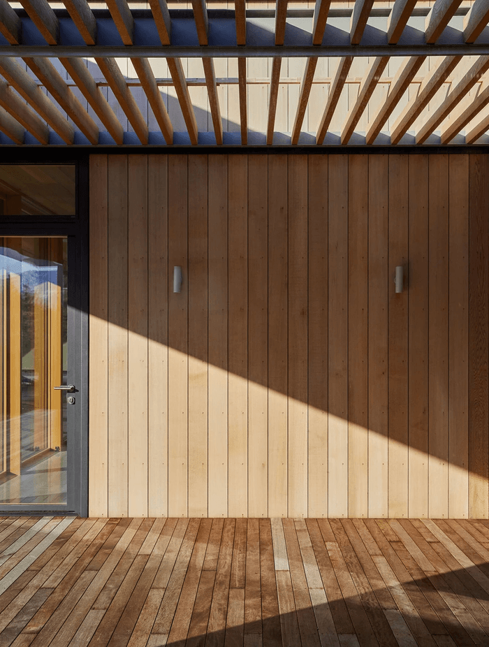 The corrugated iron cladding contrasts with the softness of timber.