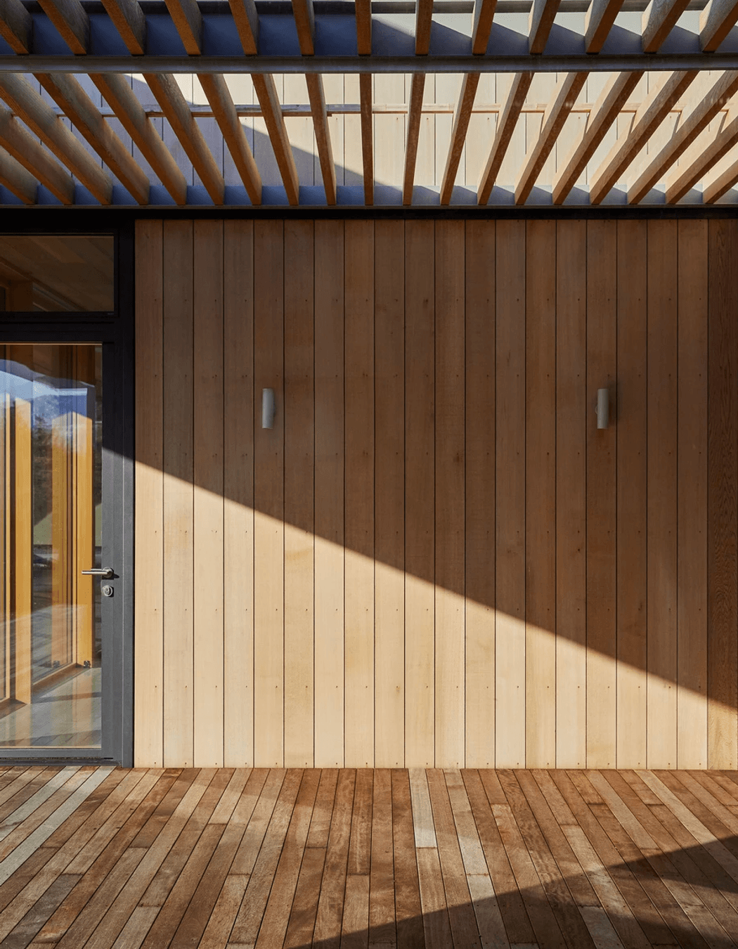 The corrugated iron cladding contrasts with the softness of timber.