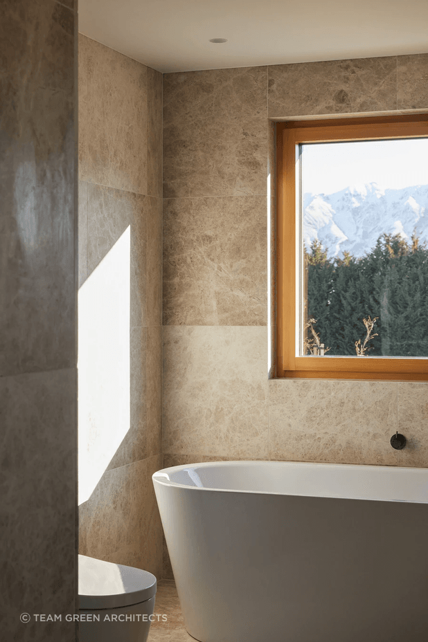 Marble stone tiles meet aged iron tapware in the bathroom.