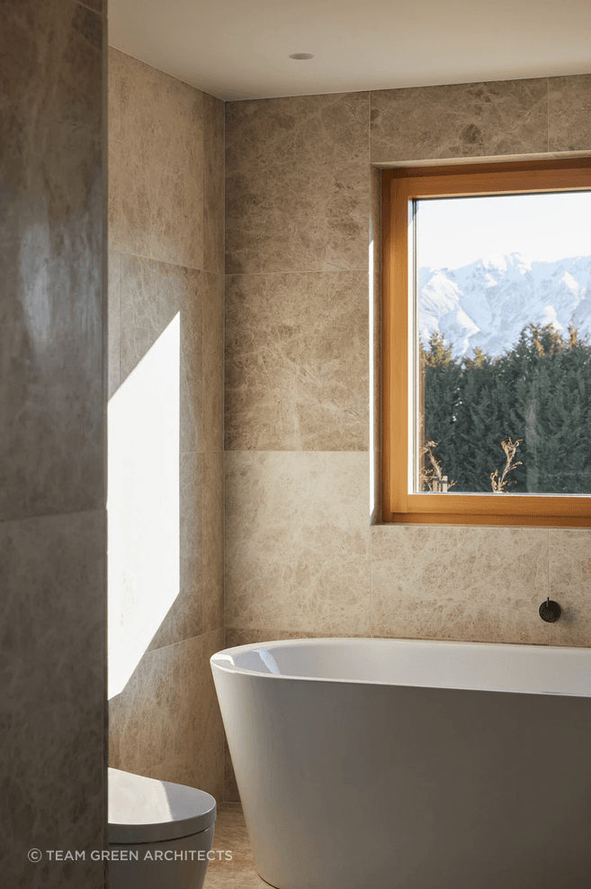 Marble stone tiles meet aged iron tapware in the bathroom.