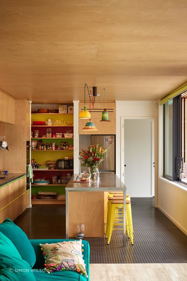 The kitchen features colourful tiles and light shades made from recycled plastic bottles for a playful, lighthearted feel.