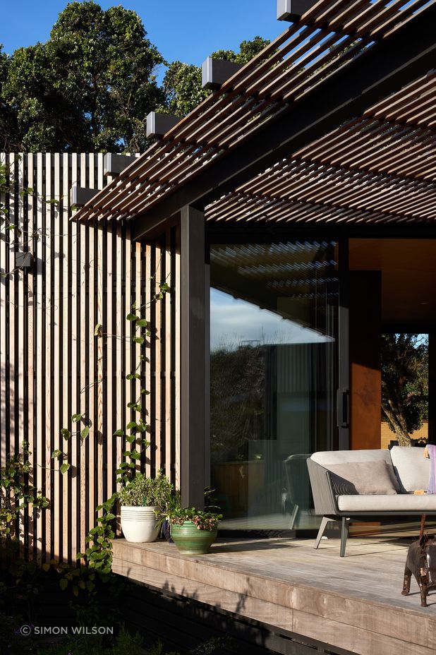 The timber battens double as a climbing frame for plants.