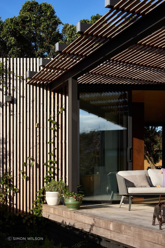 The timber battens double as a climbing frame for plants.