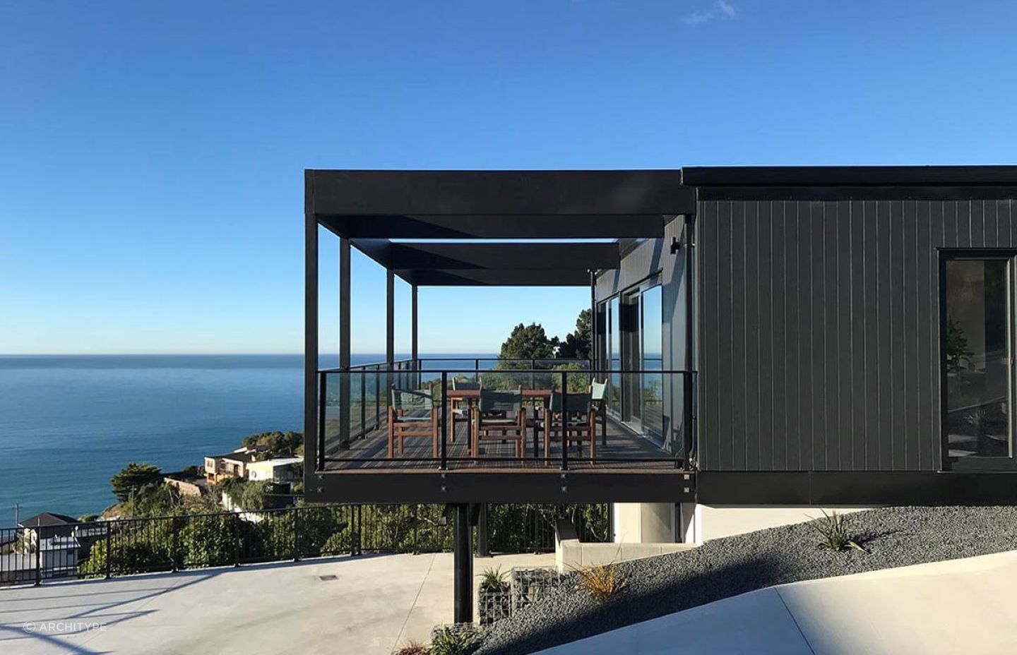 The home features cantilevered outdoor living space with movable shutters for privacy and shelter when needed.