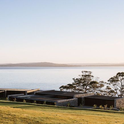 A cliffside home of wood and stone at one with the Tasmanian landscape